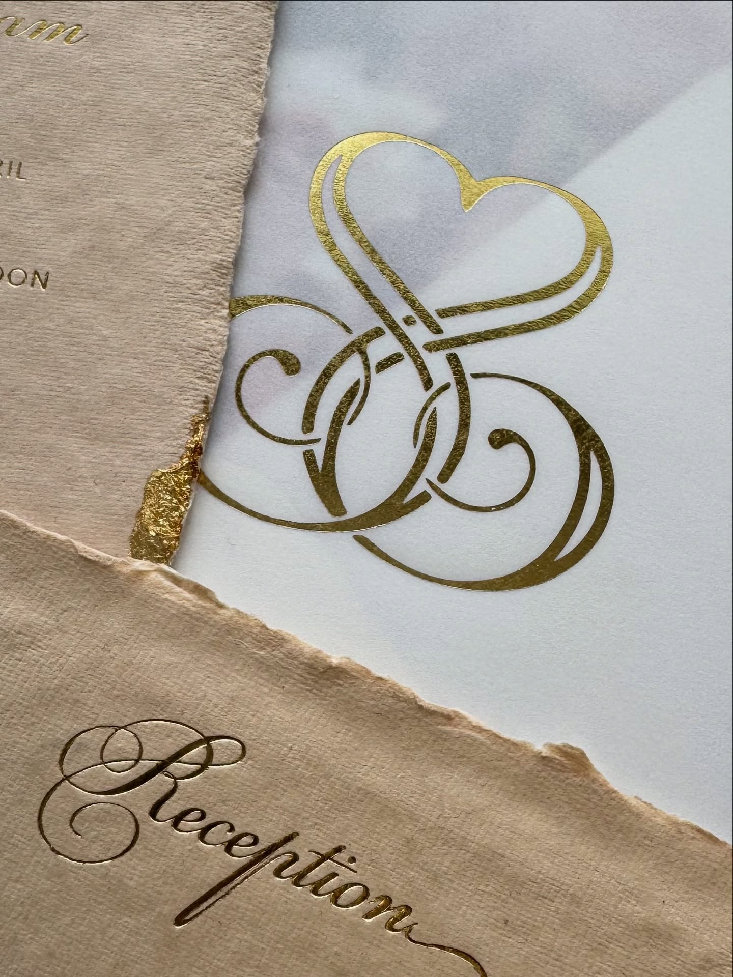Unique details for a wedding invitation, including translucent vellum, deckled paper, and gold foil stamping.